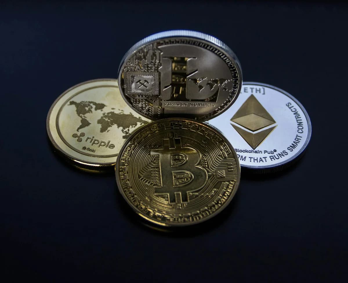 A close-up of hands holding various cryptocurrency coins, representing digital finance.