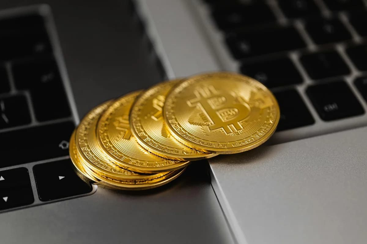 Close-up of a hand holding a Bitcoin coin, illustrating cryptocurrency concept.