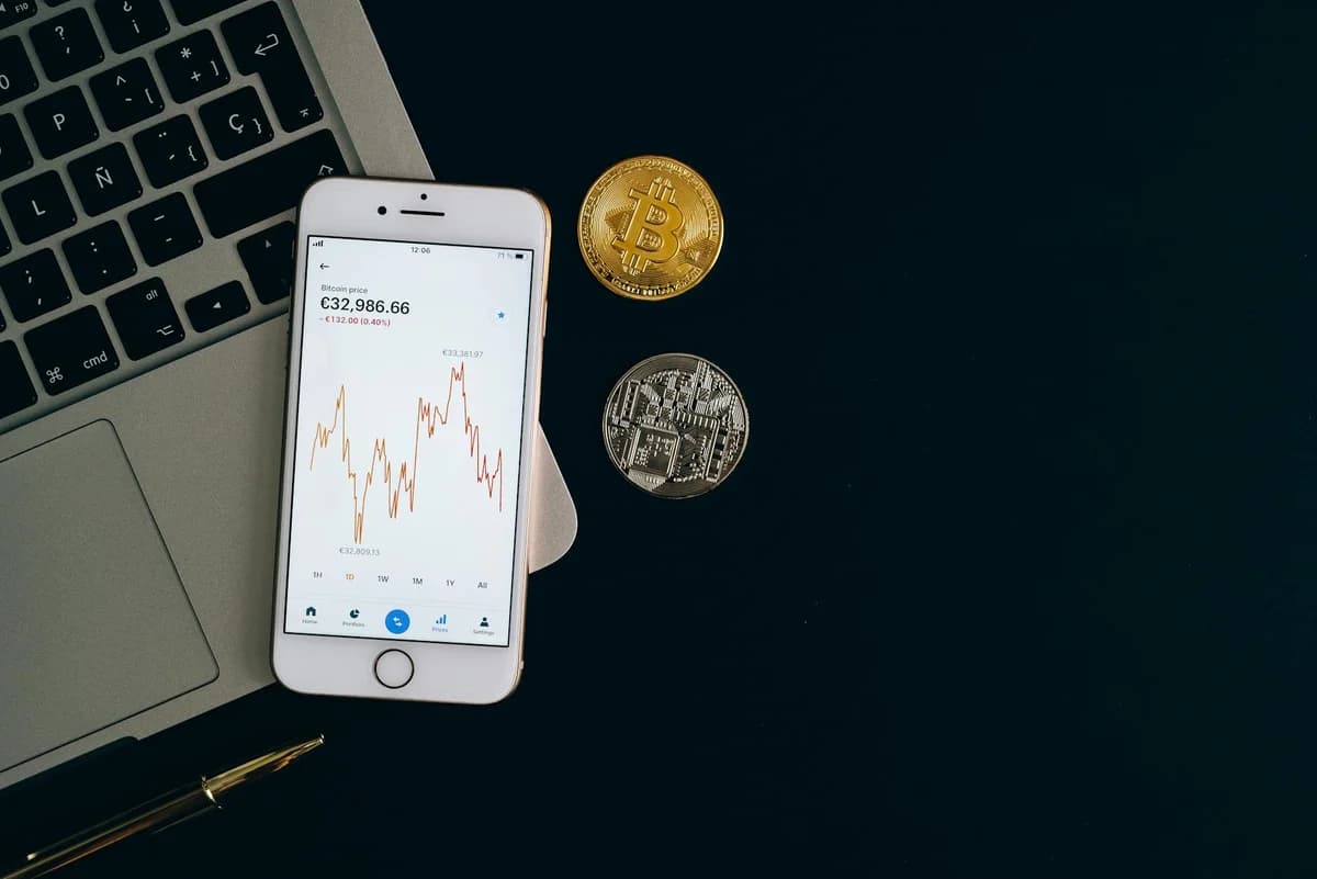 Golden bitcoin coin on background of chart showing indicators of changes in cryptocurrency rates