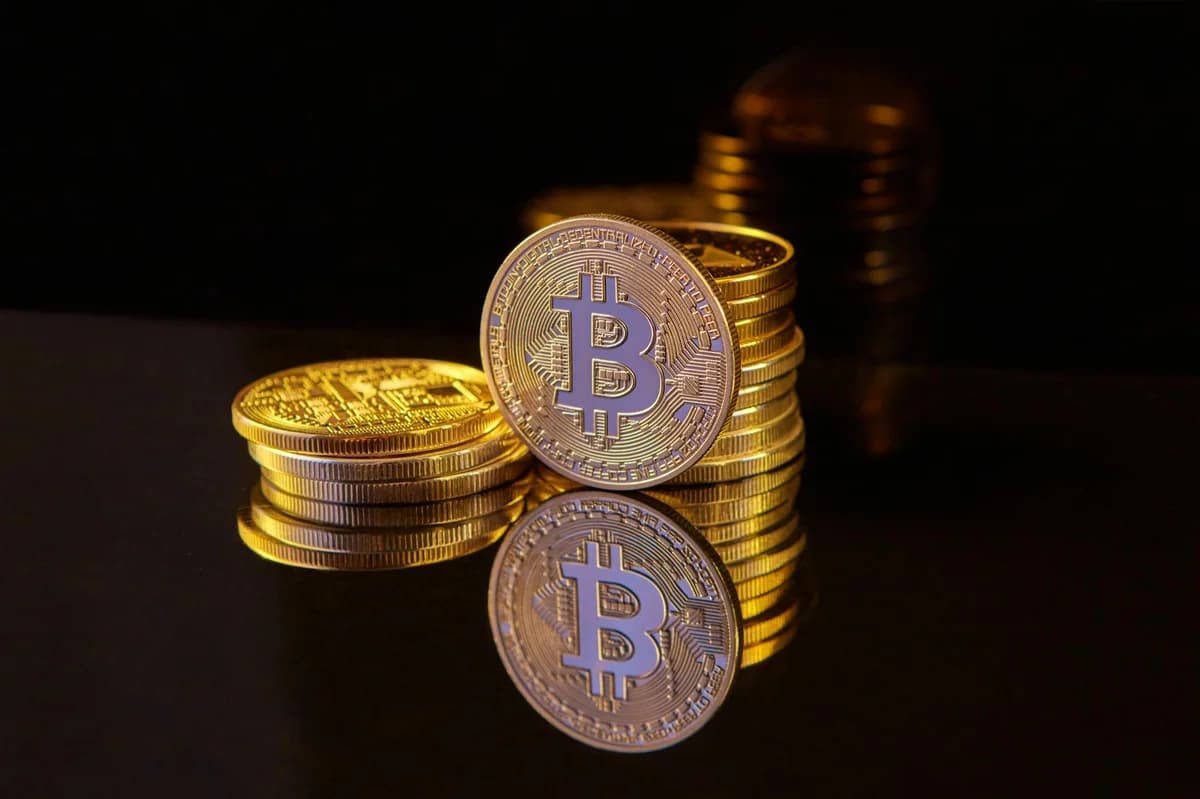 Golden Bitcoin partially buried in dark soil, signifying investment growth.