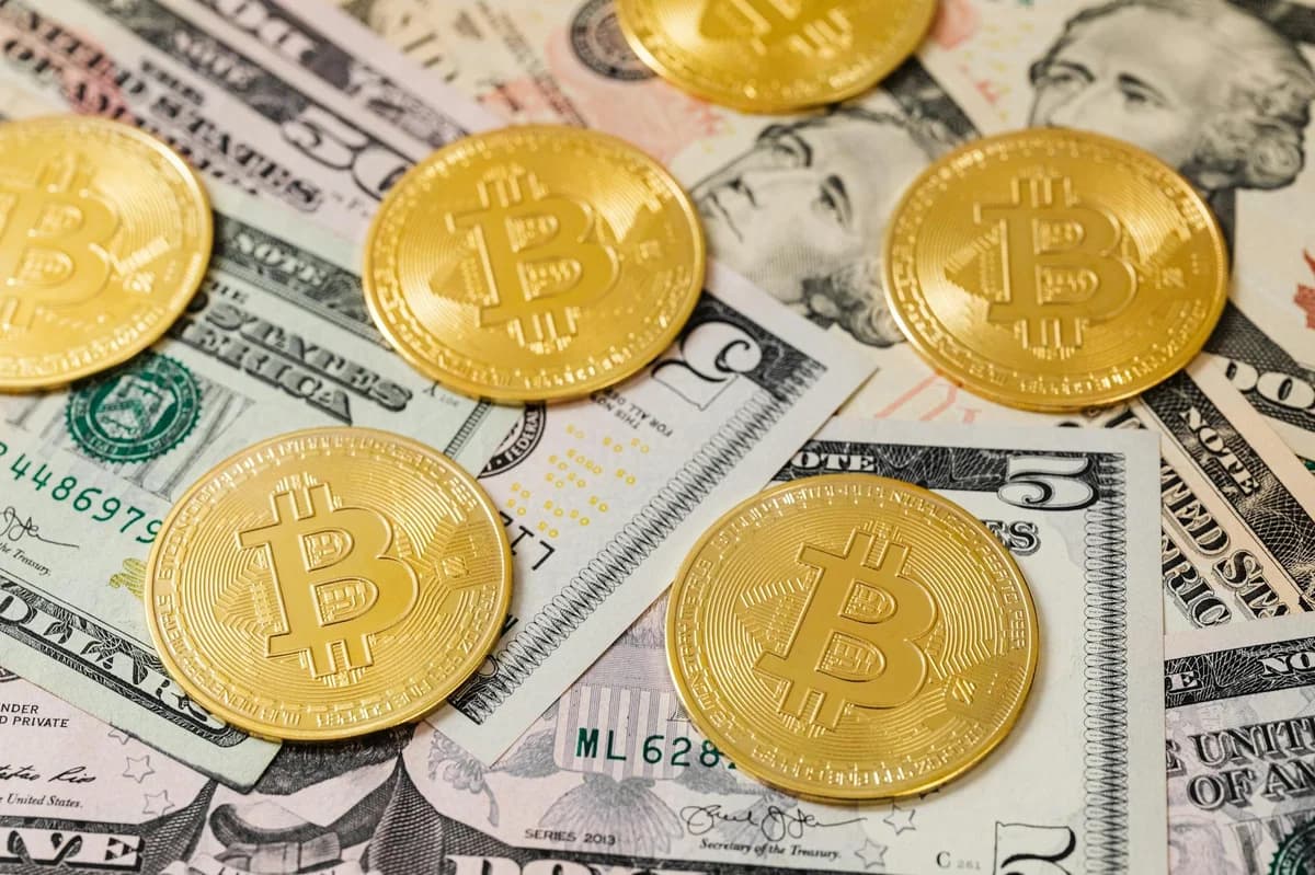 Focused shot of a Bitcoin cryptocurrency coin on a grey backdrop.