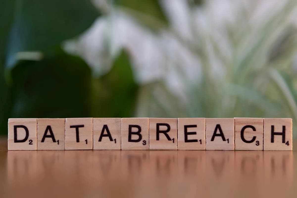 Close-up of Scrabble tiles spelling 'data breach' on a blurred background