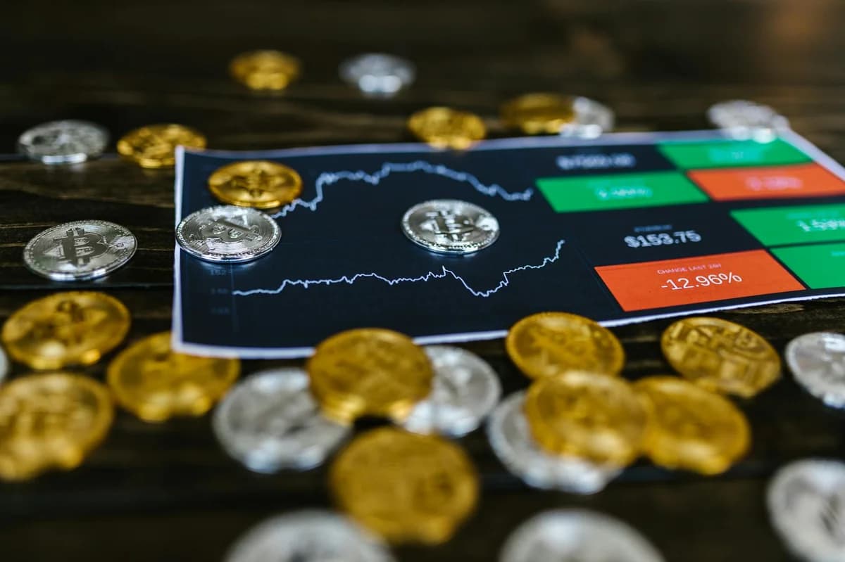 A hand holding an Ethereum coin against a rising stock market graph, symbolizing cryptocurrency growth.
