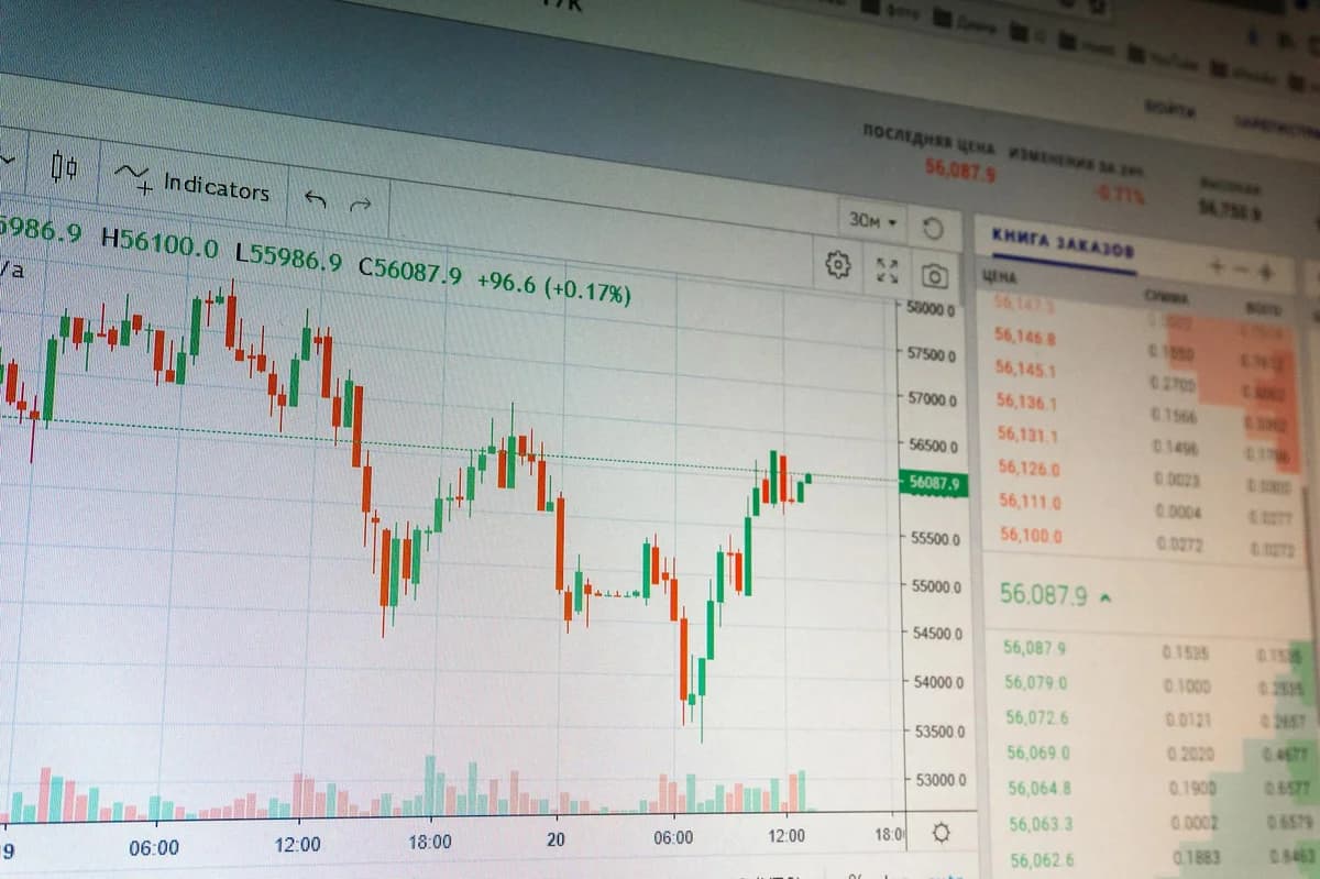 Close-up photo of a smartphone displaying cryptocurrency market data with price listings.