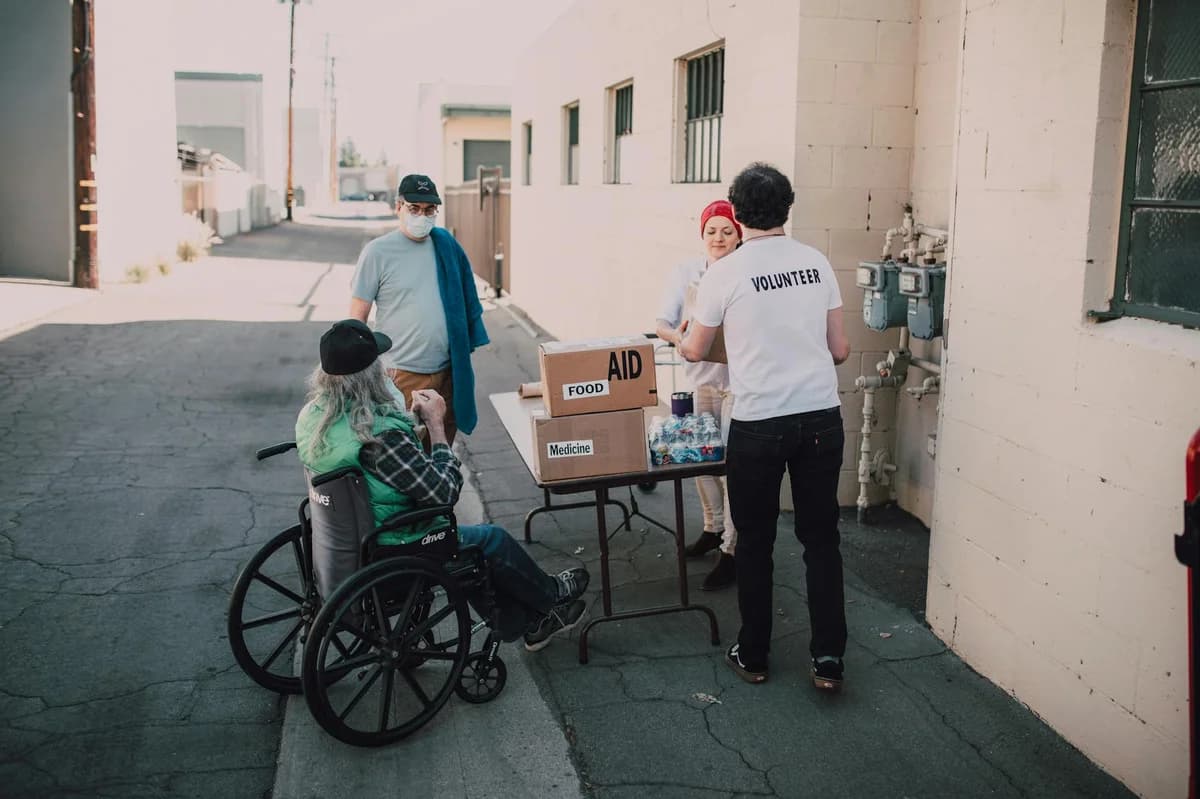 Volunteers organizing and loading boxes of aid, food, and medicine for donation.