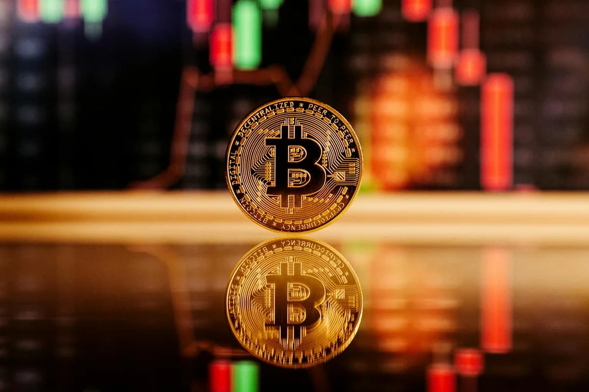 Close-up of gold Bitcoin coins on a trading document, symbolizing investment and cryptocurrency market strategies.