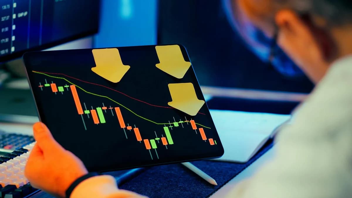 Close-up of a digital stock market graph showing falling trends and financial indices in red and green.