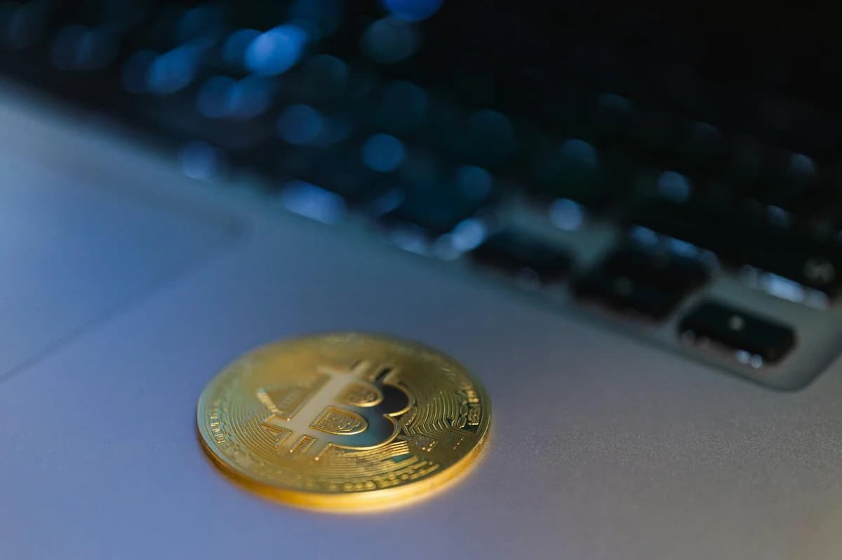 Five cryptocurrency coins displayed on a smartphone with Coinbase app open.