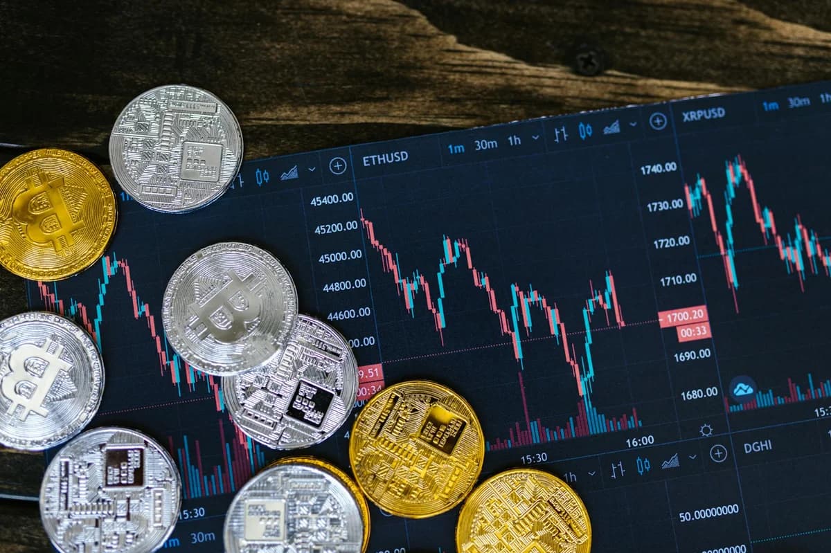 Golden bitcoins on a background of US dollar bills representing cryptocurrency and traditional money.