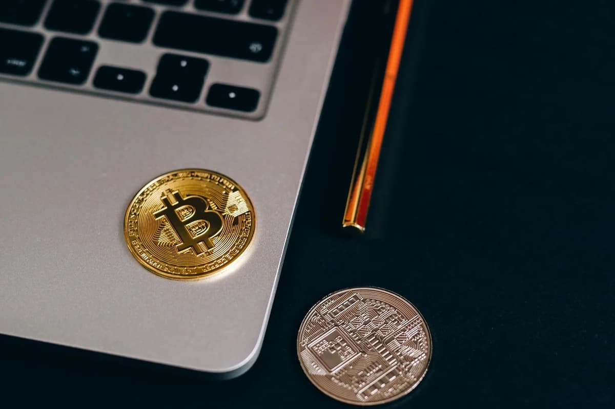 Gold Bitcoin coins on top of a cryptocurrency investment guide. High-quality finance and cryptocurrency image.
