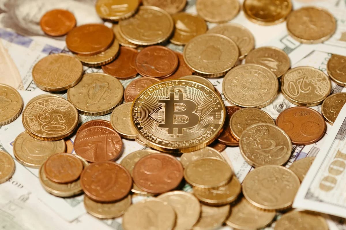 Close-up of digital cryptocurrency coins and Euro banknotes, representing modern finance.