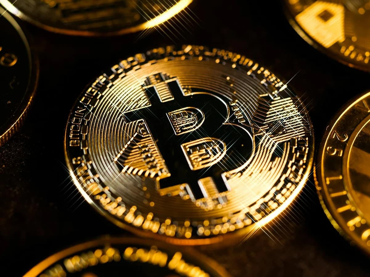 Close-up image of Bitcoin and Litecoin coins on geometric patterned surface.