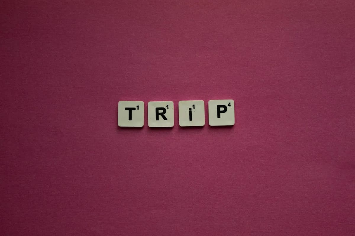 Wooden letter tiles spelling 'Pseudonym' on a table with a blurred background.