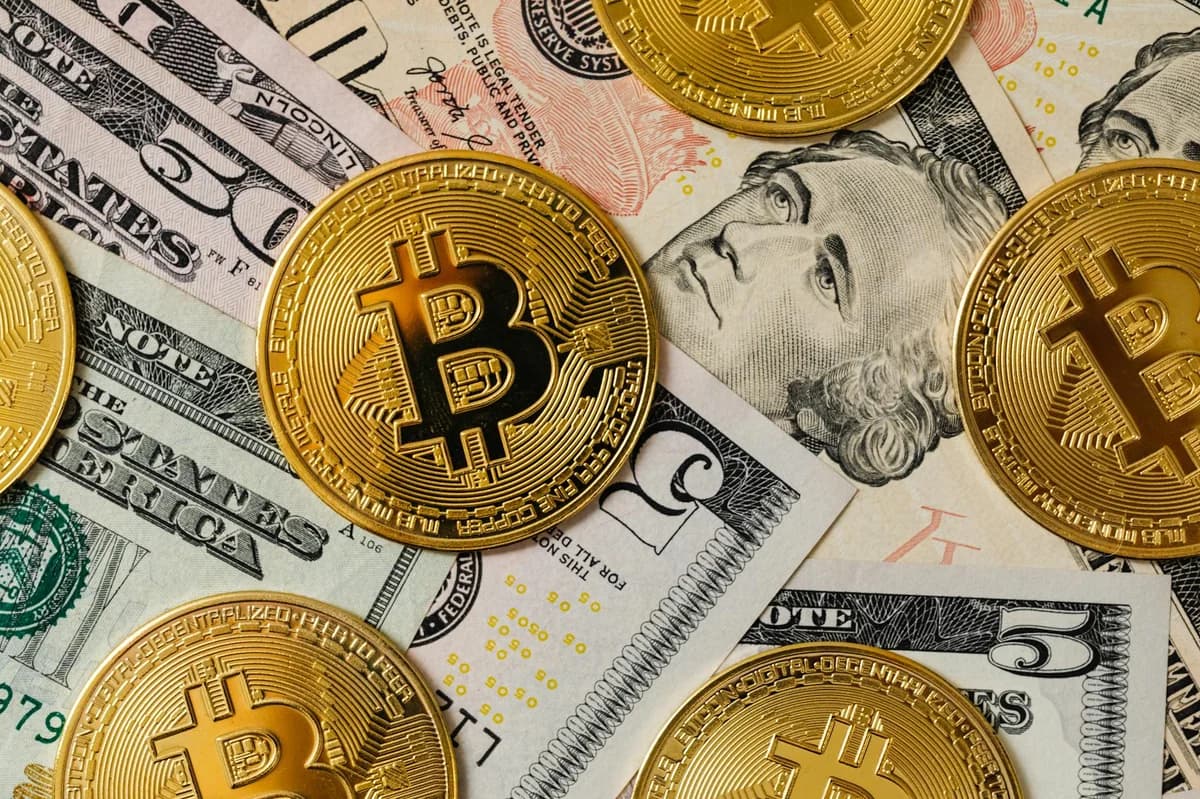 Close-up of Bitcoin trading app on smartphone showing market trends and digital coins.