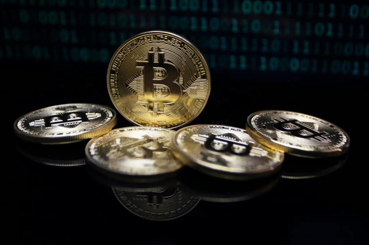 A gold Bitcoin coin partially buried in dark soil symbolizing digital currency growth.