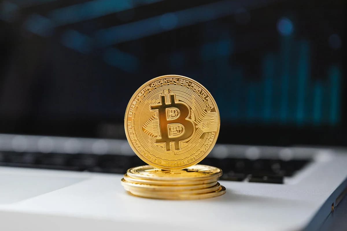 Close-up of bitcoins on a shimmering gold background, symbolizing digital wealth and investment.