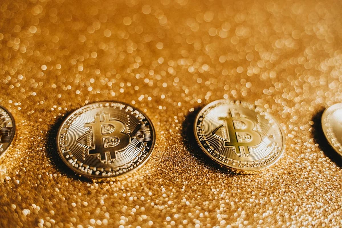 Bitcoin coin placed on a bright yellow background offering ample copy space.