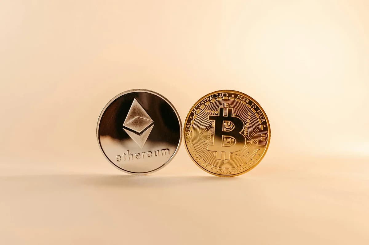 Stacked bitcoin coins on a reflective surface with a vibrant digital glow, symbolizing wealth and cryptocurrency.