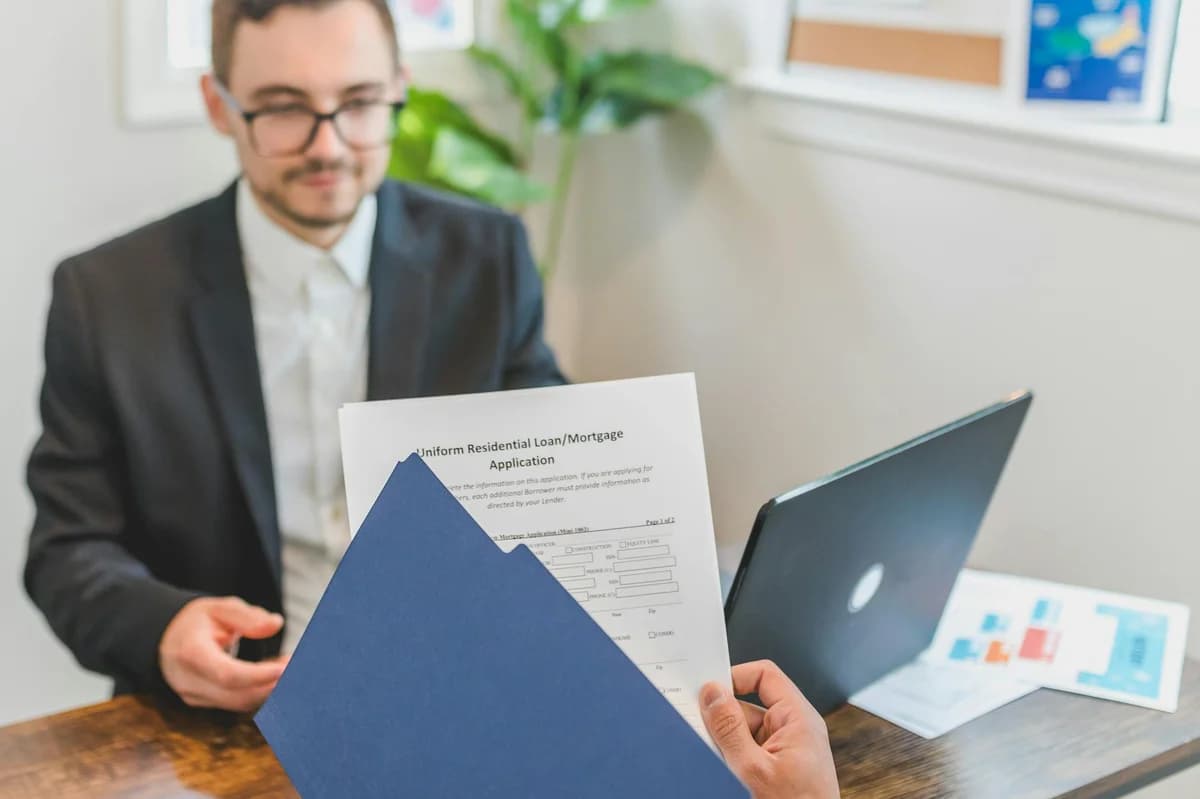 Detailed loan agreement document close-up on a wooden table representing legal and financial concepts.