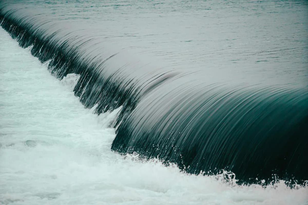 Dynamic image of a cascading waterfall with smooth flowing rapids and serene water motion.