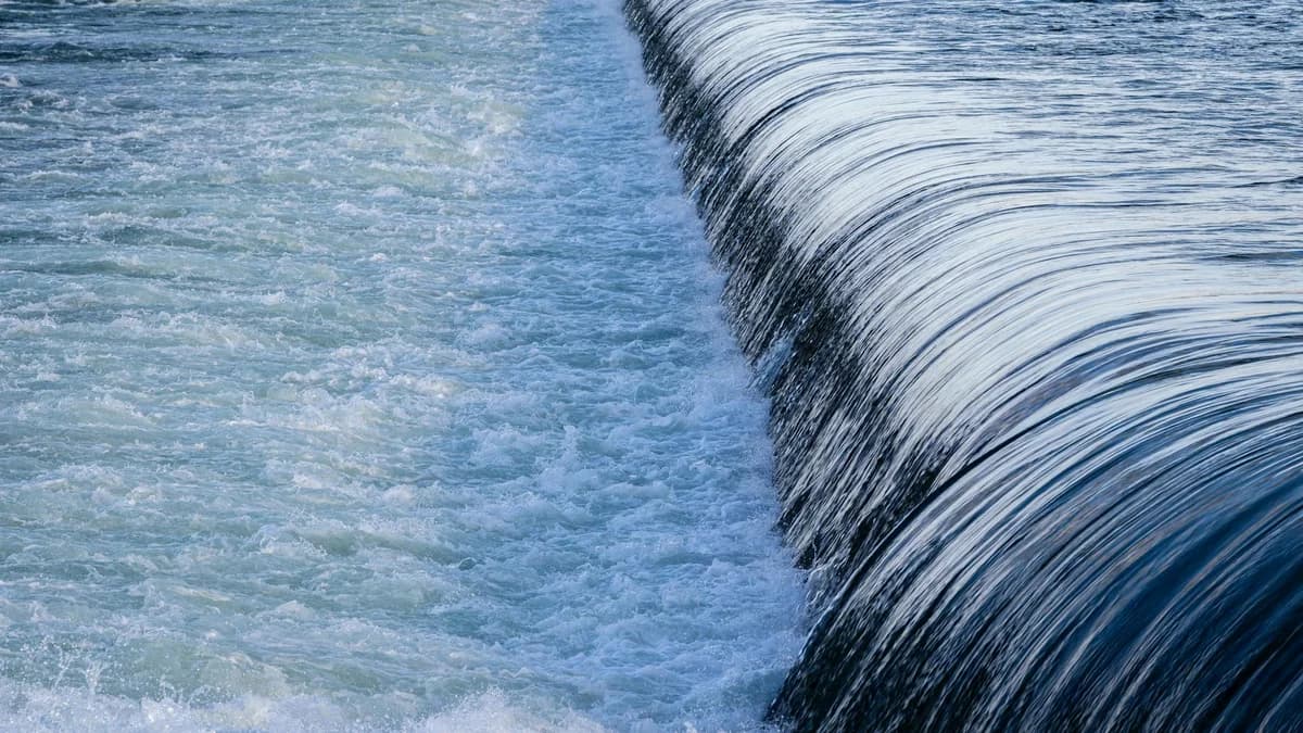 A tranquil scene of a flowing waterfall in motion, showcasing its power and beauty.