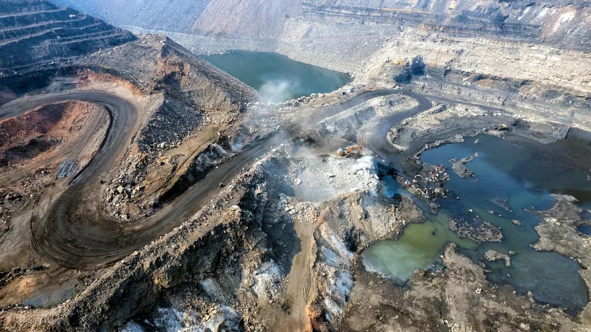 Expansive aerial shot of an active coal mine in Dhanbad, Jharkhand, India.