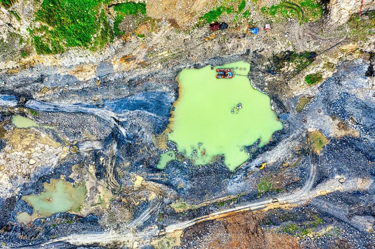 Capture of a quarry with vibrant green pools in Rumpin, Indonesia.
