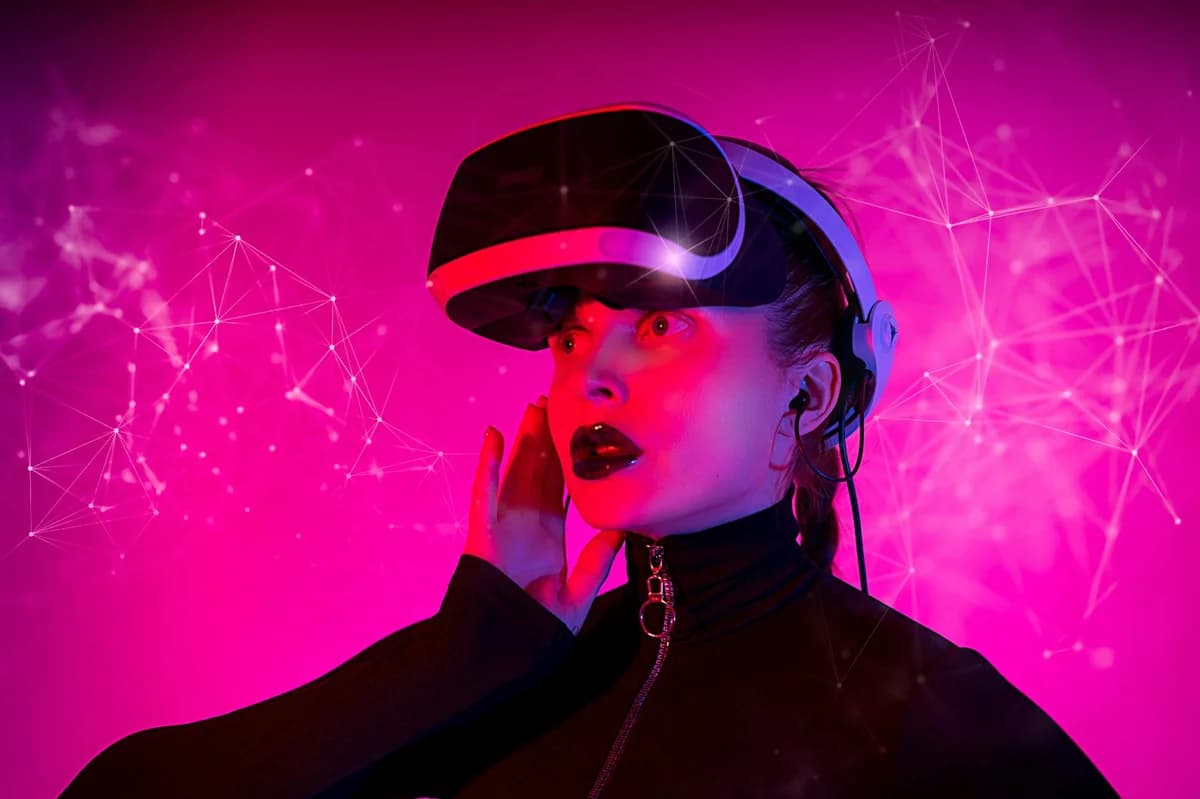 Woman experiencing virtual reality with VR headset and pink futuristic digital background.