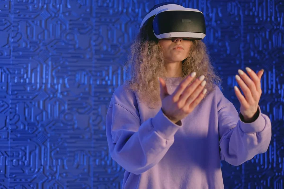 A woman experiencing virtual reality gaming with VR headset in a modern tech setting.