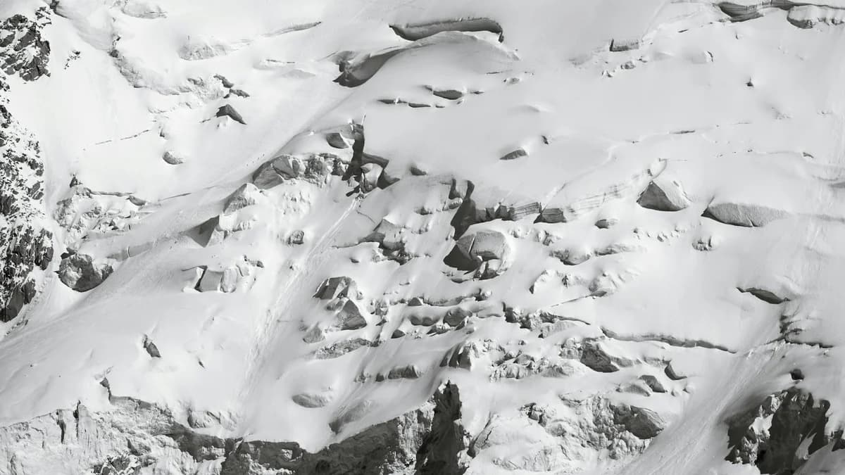Snowcat removes snow on Jungfraujoch, Switzerland. Bright day in picturesque alpine landscape.