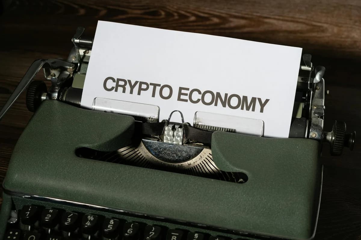 Close-up of a vintage typewriter with paper reading 'Crypto Economy', symbolizing modern concepts with retro technology.