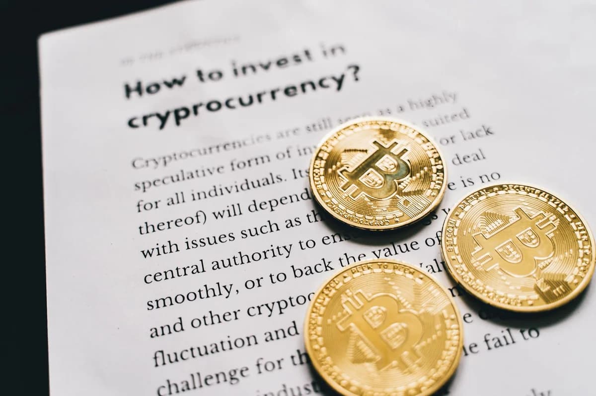 Close-up of gold bitcoin coins on a laptop keyboard, symbolizing digital currency and technology.