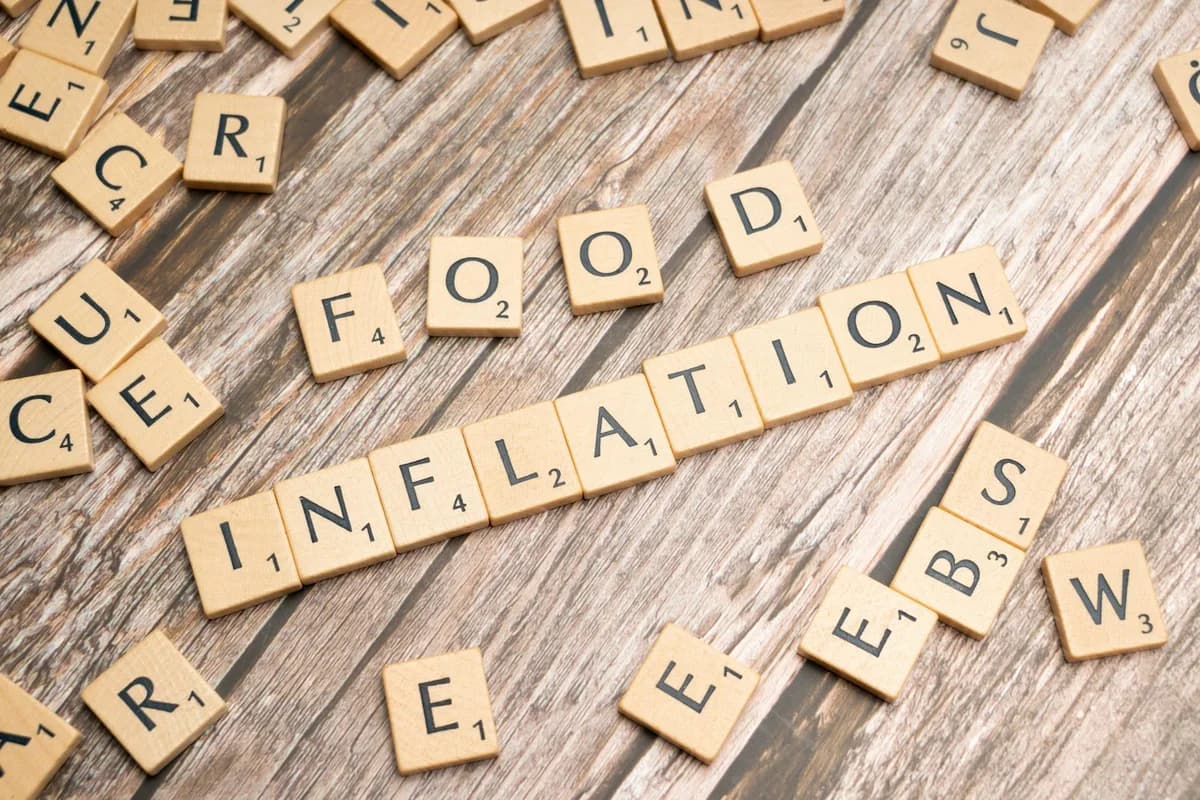 Wooden letter tiles forming the word 'inflation' on a rustic wooden surface, symbolizing economic themes.