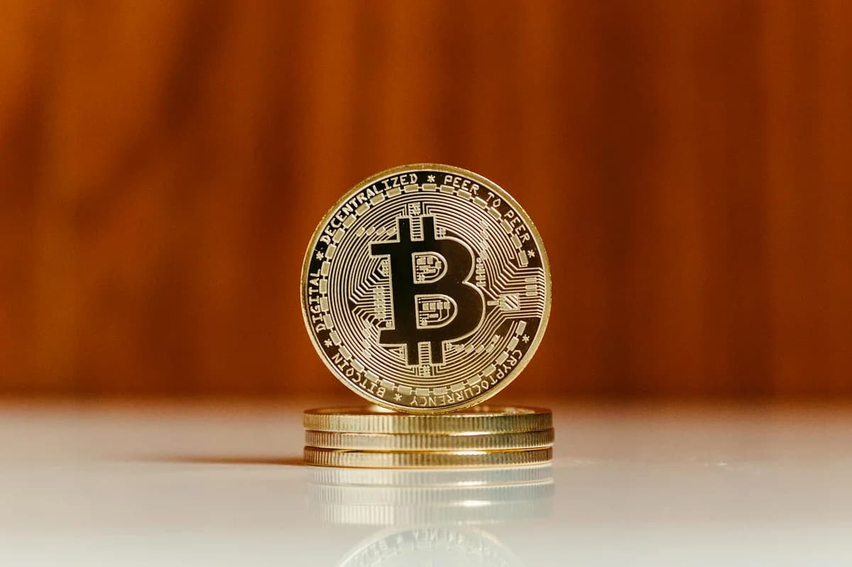 Golden bitcoin coin standing on stack. Ideal for cryptocurrency and blockchain illustrations.