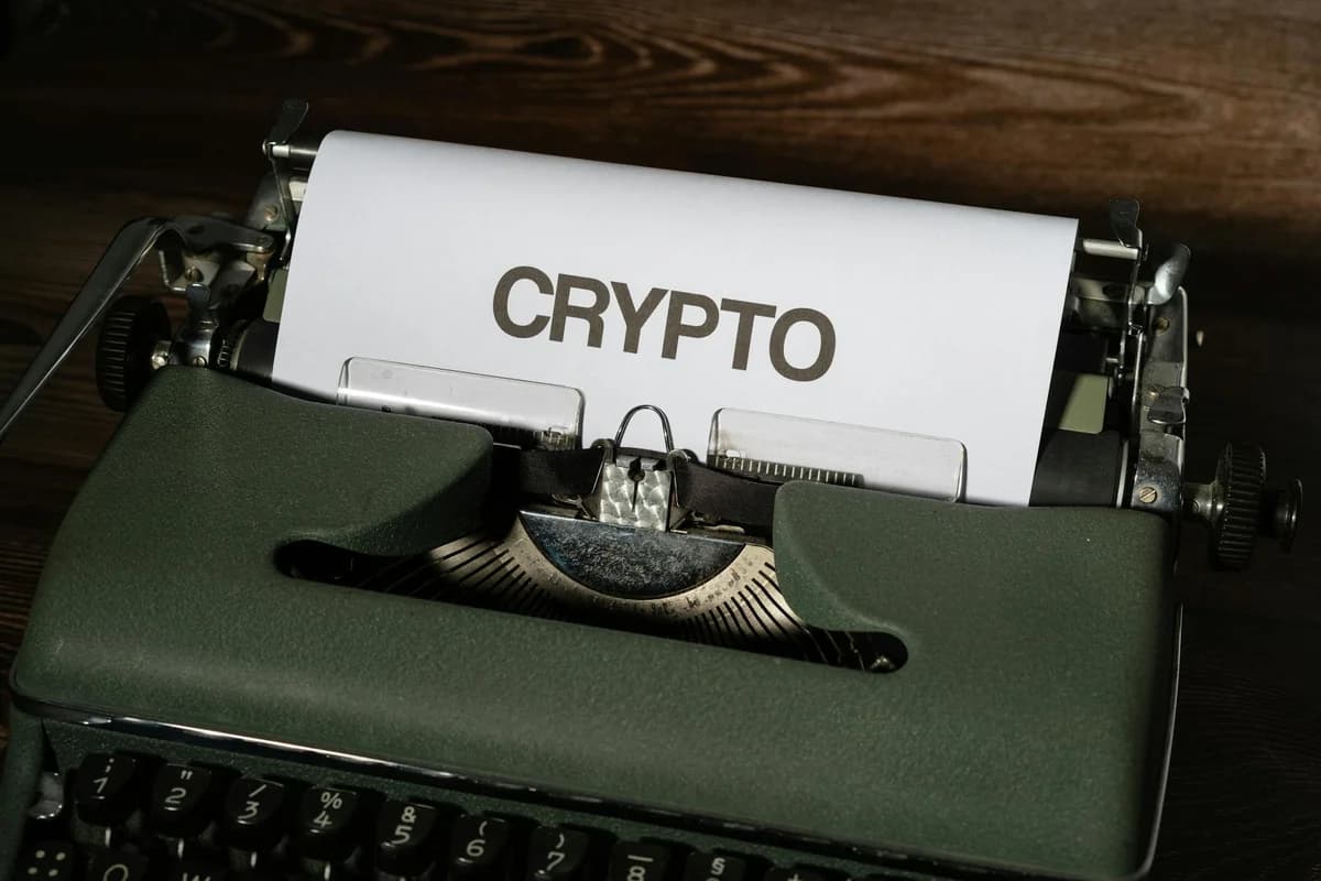 A classic typewriter displaying the word 'crypto' on paper, symbolizing digital currency's vintage connection.