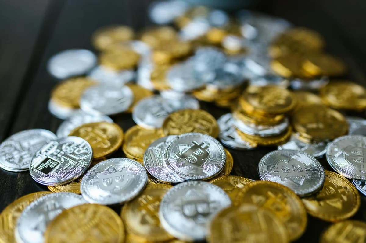 Close-up of a gold Bitcoin coin with reflective surface, ideal for financial and tech themes.