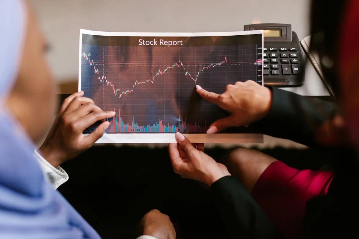 Detailed close-up of a financial chart on a black surface, showing stock market analysis.