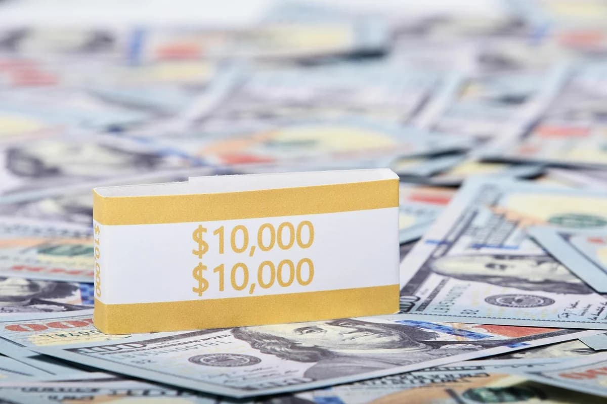 Detailed close-up of layered US dollar banknotes focusing on geometric patterns and financial concept.