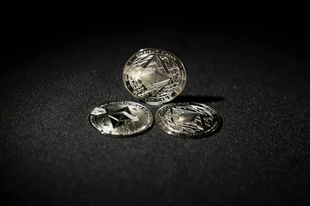Close-up of an Ethereum coin placed on a circuit board, symbolizing digital currency technology.