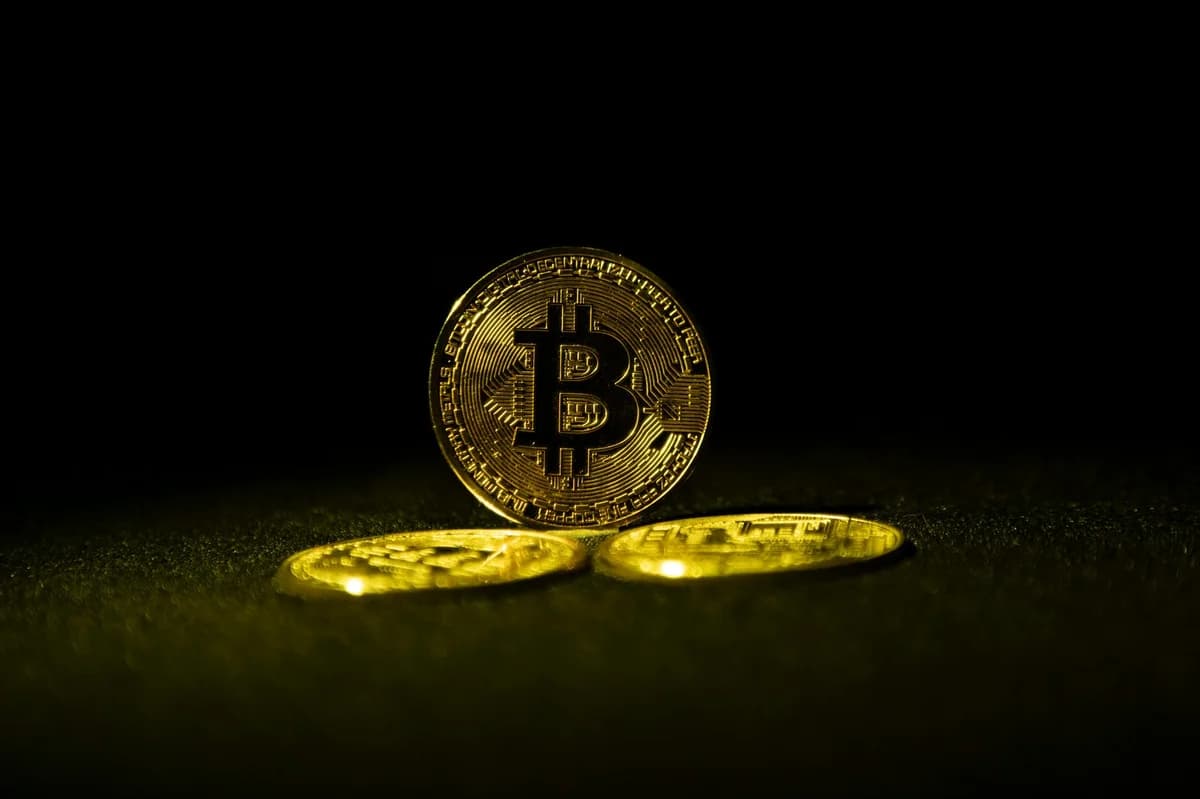 Close-up of a Bitcoin coin on a soft, neutral background representing the digital currency concept.