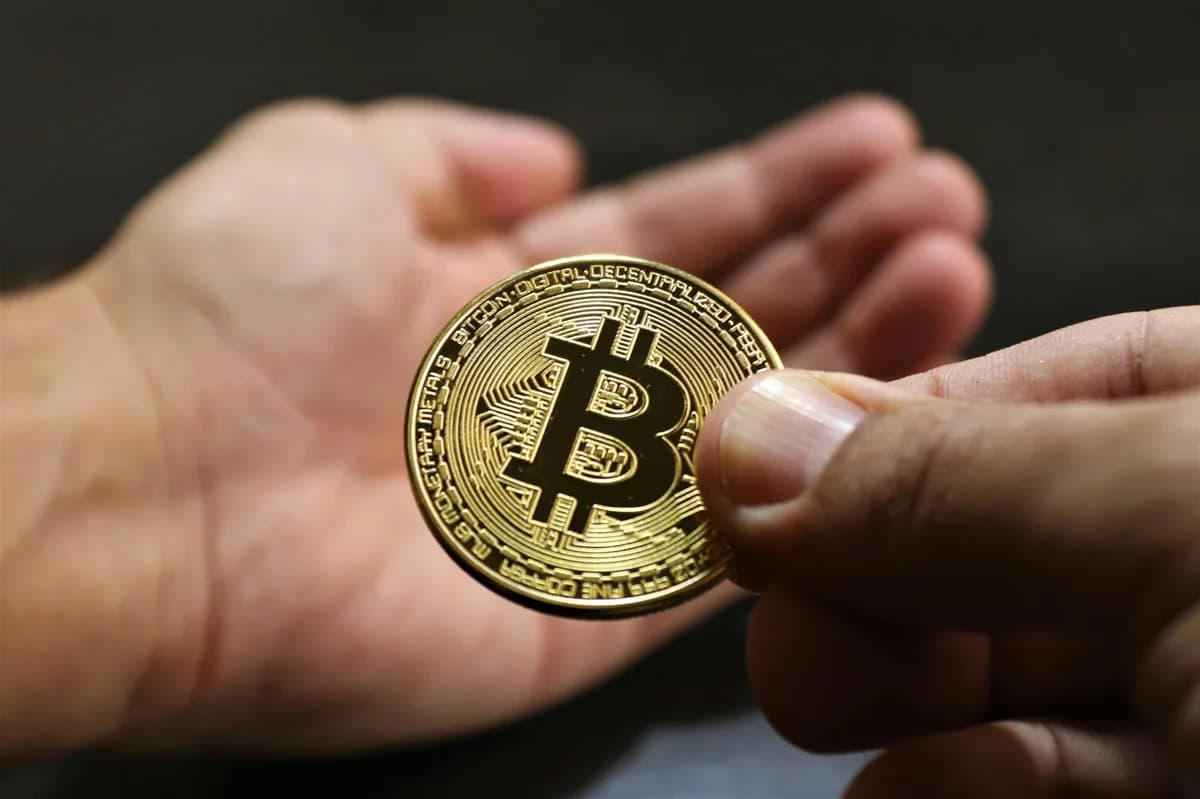 Close-up of multiple Bitcoin coins on a laptop keyboard symbolizing digital currency and cryptocurrency trading.