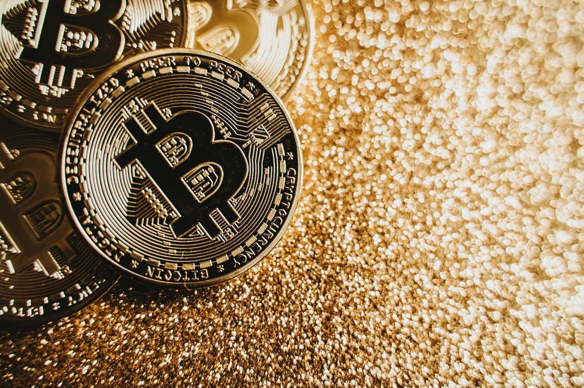 Close-up view of Bitcoin coins on a stock market chart background representing cryptocurrency trading.