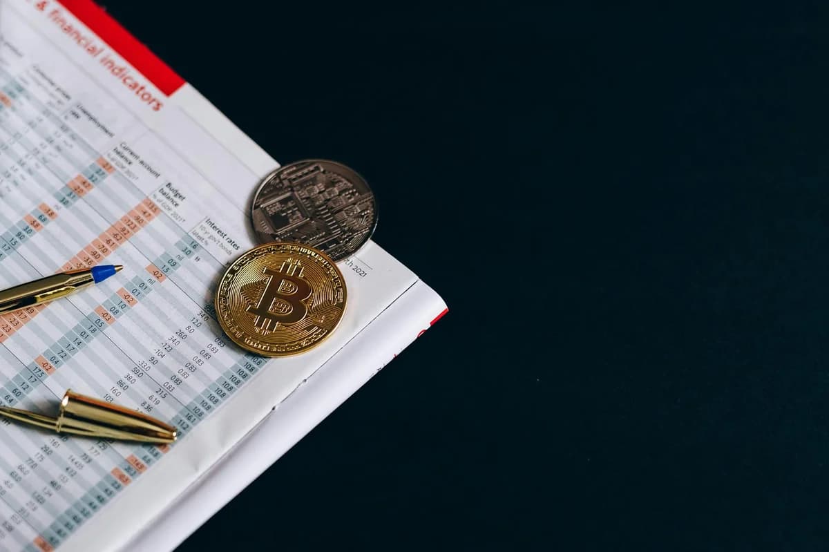 How Interest Rate Decisions Affect Crypto Markets Smartphone with bitcoins on calendar, marking investment date.