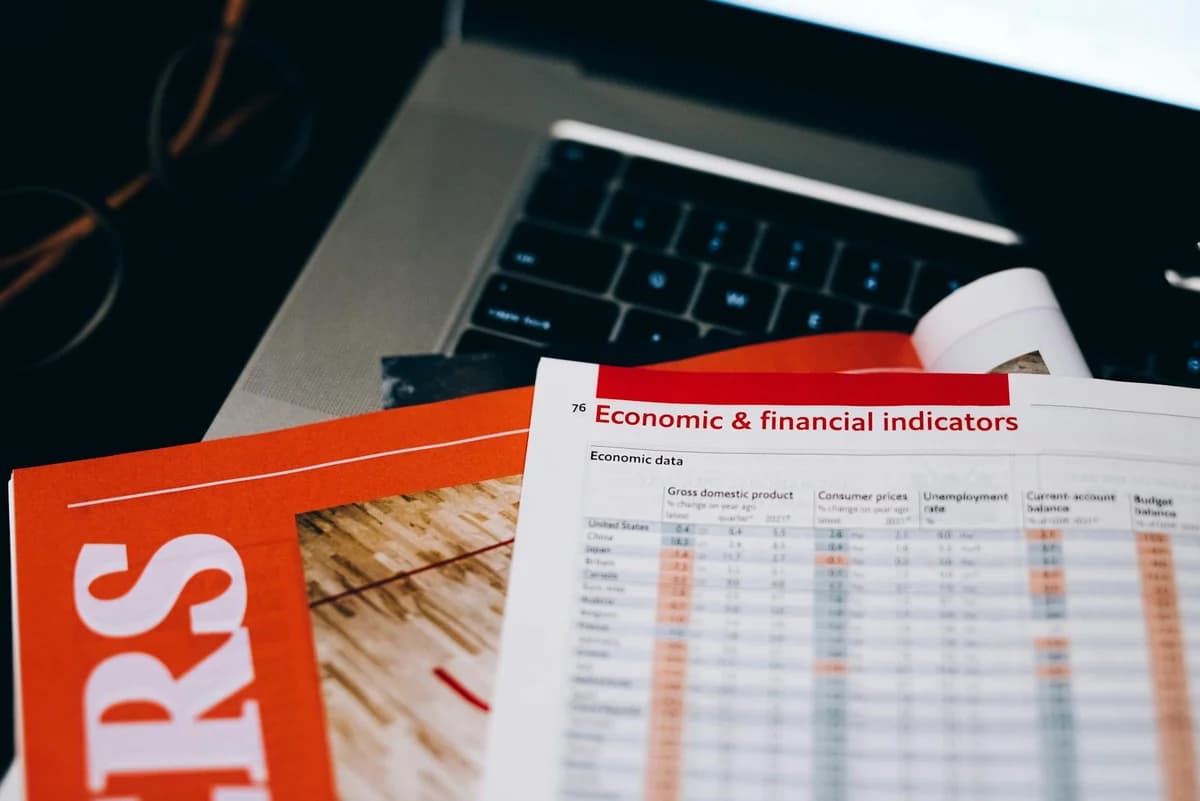 What Is the Reserve Risk Indicator? A Beginner's Guide Detailed close-up of economic and financial documents on a laptop keyboard, highlighting data analytics.